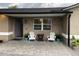Charming front porch with stone flooring, seating and lovely blue planters at the entrance of this home at 170 N Fairfax Ave, Winter Springs, FL 32708