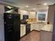 Bright eat-in kitchen features stainless steel appliances, granite countertops, painted cabinets and a window at 170 N Fairfax Ave, Winter Springs, FL 32708