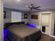Comfortable main bedroom with a platform bed, modern decor, wood-look accent wall, and ceiling fan at 170 N Fairfax Ave, Winter Springs, FL 32708