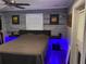 A bright main bedroom with a platform bed, wall decor, modern decor, wood-look accent wall, and ceiling fan at 170 N Fairfax Ave, Winter Springs, FL 32708