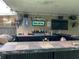 This outdoor bar features a tile countertop, built-in grill, fridge, lights and fan, with entertainment ready for guests at 170 N Fairfax Ave, Winter Springs, FL 32708