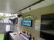 Outdoor bar area features a sink, fan, lights, bar refrigerator, television, and a River Life Pub sign at 170 N Fairfax Ave, Winter Springs, FL 32708