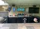 This outdoor bar features a tile countertop, built-in grill, fridge, lights and fan, entertainment ready for guests at 170 N Fairfax Ave, Winter Springs, FL 32708