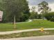 A park area with mature trees, green grass, walking paths, and a blue fire hydrant at 170 N Fairfax Ave, Winter Springs, FL 32708