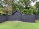 View of the shed in the backyard featuring a low-maintenance artificial turf lawn at 170 N Fairfax Ave, Winter Springs, FL 32708