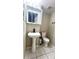 Bathroom featuring a modern pedestal sink with a black faucet and a toilet on a tiled floor at 1815 Townhall Ln # 1815, Orlando, FL 32807
