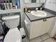Cozy bathroom featuring a vanity with gray countertops and white cabinetry, along with a toilet with storage at 1815 Townhall Ln # 1815, Orlando, FL 32807