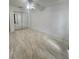 Spacious bedroom with tile floors, ceiling fan, and a mirrored closet at 1815 Townhall Ln # 1815, Orlando, FL 32807