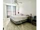 Bright bedroom with a ceiling fan, window, neutral walls, and tiled floors at 1815 Townhall Ln # 1815, Orlando, FL 32807
