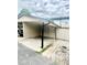 Attached carport featuring covered parking and adjacent fenced area, providing outdoor privacy at 1815 Townhall Ln # 1815, Orlando, FL 32807
