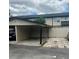 Attached carport with parking and an adjacent fenced area offering outdoor privacy at 1815 Townhall Ln # 1815, Orlando, FL 32807