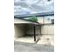 Attached carport offering covered parking and convenient access to the home's fenced outdoor area at 1815 Townhall Ln # 1815, Orlando, FL 32807