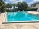 Refreshing community pool surrounded by palm trees, ideal for relaxation and recreation at 1815 Townhall Ln # 1815, Orlando, FL 32807