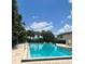 Sparkling community pool surrounded by palm trees, perfect for a refreshing swim at 1815 Townhall Ln # 1815, Orlando, FL 32807