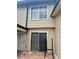 Exterior features siding, a window, sliding glass door, and a red brick patio at 1815 Townhall Ln # 1815, Orlando, FL 32807