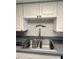 The kitchen boasts a stainless steel sink and faucet, complemented by ample counter space at 1815 Townhall Ln # 1815, Orlando, FL 32807