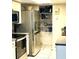 This kitchen shows stainless steel appliances and storage in pantry and cabinets at 1815 Townhall Ln # 1815, Orlando, FL 32807