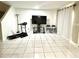 The living room features tile floors, a TV, and a treadmill at 1815 Townhall Ln # 1815, Orlando, FL 32807
