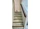 Elegant staircase featuring marble tile steps and a wood handrail at 1815 Townhall Ln # 1815, Orlando, FL 32807