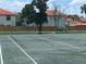 Community tennis court surrounded by lush greenery, offering a scenic backdrop at 1815 Townhall Ln # 1815, Orlando, FL 32807