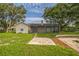 Large backyard with lush green grass, patio, and a screened in porch at 1840 Orange View Ct, Kissimmee, FL 34746