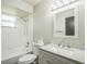 Updated bathroom with white cabinets, tub and shower combo, and modern fixtures at 1840 Orange View Ct, Kissimmee, FL 34746