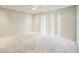 An empty bedroom with carpet, a ceiling fan, and sliding door for natural light at 1840 Orange View Ct, Kissimmee, FL 34746