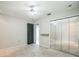 Bedroom featuring neutral carpet, mirrored closet doors, ceiling fan, and a large window at 1840 Orange View Ct, Kissimmee, FL 34746