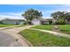 View of a well-kept single Gathering home on a quiet street with a lush green lawn at 1840 Orange View Ct, Kissimmee, FL 34746