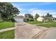 View of a well-kept single Gathering home with a long driveway and a lush green lawn at 1840 Orange View Ct, Kissimmee, FL 34746