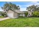 Inviting single-Gathering home with well-maintained lawn, attached garage, and a lovely blue front door at 1840 Orange View Ct, Kissimmee, FL 34746