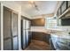 This kitchen view features dark cabinets, white countertops, stainless steel appliances and hard wood floors at 1840 Orange View Ct, Kissimmee, FL 34746