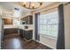 Kitchen features dark cabinets, white countertops, black appliances, hardwood flooring, and a window view at 1840 Orange View Ct, Kissimmee, FL 34746