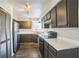 This kitchen features dark cabinets, white countertops, stainless steel appliances and hard wood floors at 1840 Orange View Ct, Kissimmee, FL 34746