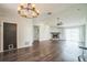 Spacious living room featuring vaulted ceilings, wood flooring, a fireplace, and a modern chandelier at 1840 Orange View Ct, Kissimmee, FL 34746