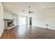 Open living area with wood floors, fireplace, a ceiling fan, and sliding glass doors to the backyard at 1840 Orange View Ct, Kissimmee, FL 34746
