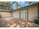 Screened in patio with outdoor lights, access doors, and concrete flooring at 1840 Orange View Ct, Kissimmee, FL 34746