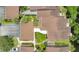 Bird's-eye view of condo rooftops with well-maintained landscaping and a parked white car at 2142 Woodbridge Rd, Longwood, FL 32779