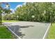 Full-size basketball court surrounded by lush greenery, perfect for recreation and outdoor activities at 2142 Woodbridge Rd, Longwood, FL 32779