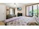 Bright bedroom featuring a large bed, flatscreen television, and sliding glass door at 2142 Woodbridge Rd, Longwood, FL 32779
