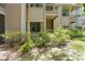 Multi-story condominium complex with private patios and balconies surrounded by lush greenery at 2142 Woodbridge Rd, Longwood, FL 32779