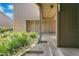 Well-maintained condo exterior with a covered entrance, lush plants, and a paved walkway at 2142 Woodbridge Rd, Longwood, FL 32779