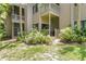 Multi-story condominium complex with private patios and balconies surrounded by lush greenery at 2142 Woodbridge Rd, Longwood, FL 32779