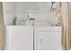 A functional laundry area with a white washer and dryer set and a Rheem water heater at 2142 Woodbridge Rd, Longwood, FL 32779