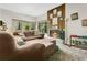 Cozy living room featuring a warm fireplace and large windows with picturesque views at 2142 Woodbridge Rd, Longwood, FL 32779