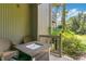 Cozy patio with an outdoor table and wicker chairs, nestled amidst lush greenery at 2142 Woodbridge Rd, Longwood, FL 32779