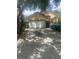 Beige single-Gathering home showing a closed two car garage door with driveway at 2155 Fennell St, Maitland, FL 32751
