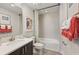 Well-lit bathroom featuring a stylish vanity, modern fixtures, and a shower-tub combo, accented with colorful artwork at 2583 Long Pine Ave, Apopka, FL 32712