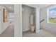 A clean and crisp hallway showcases a peek into a bedroom as well as a storage closet at 2583 Long Pine Ave, Apopka, FL 32712