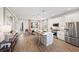 Bright, modern kitchen featuring stainless steel appliances, a center island with seating, and an adjacent dining area at 2583 Long Pine Ave, Apopka, FL 32712